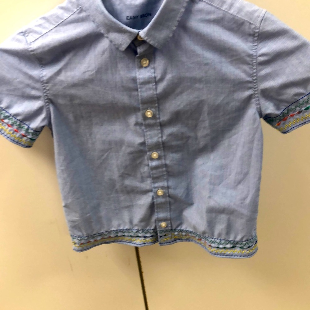 This custom embroidered shirt is one of a kind. It measures 12” across the back.